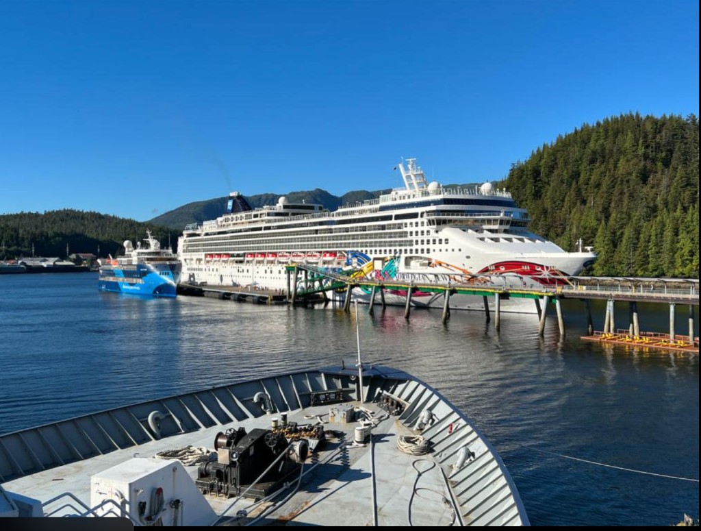 Cruise ship docked at Ward Cove, Alaska with forested mountains